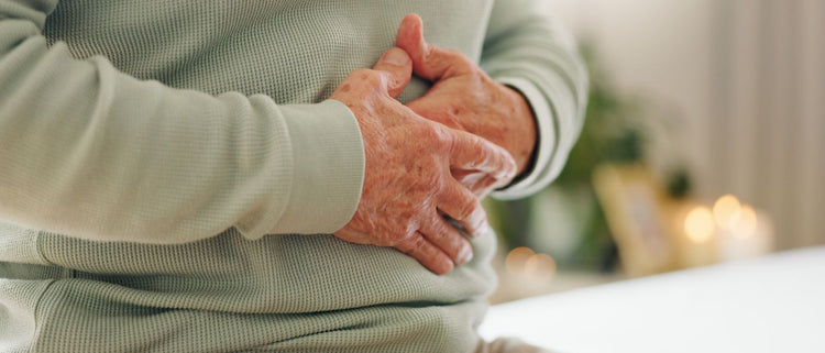 Blog of How to Detox Naturally: Supporting Essential Organs Through Toxin Overload which have image person holding their stomach