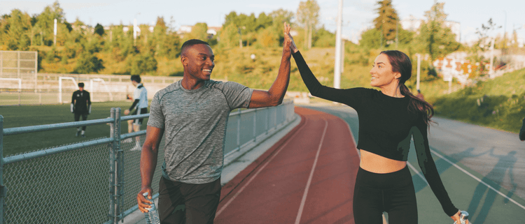Blog of Exercise for Gut Health: How Does Exercise Affect the Gut Microbiome? which have image Two fitness friends high fiving
