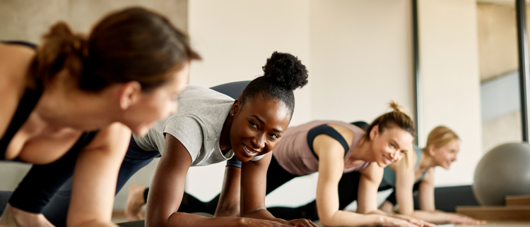 Blog of 11 Best Fitness Supplements to Power Your Workouts which have image A diverse group of women in an exercise class, smiling and engaging in a fun and energetic workout session, promoting fitness, teamwork, and positivity.