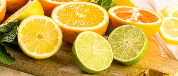 Blog of Best Vitamin C for Absorption: How to Maximize Its Benefits which have image A close-up of freshly sliced citrus fruits, including lemons, limes, oranges, and grapefruits, arranged on a wooden cutting board. 